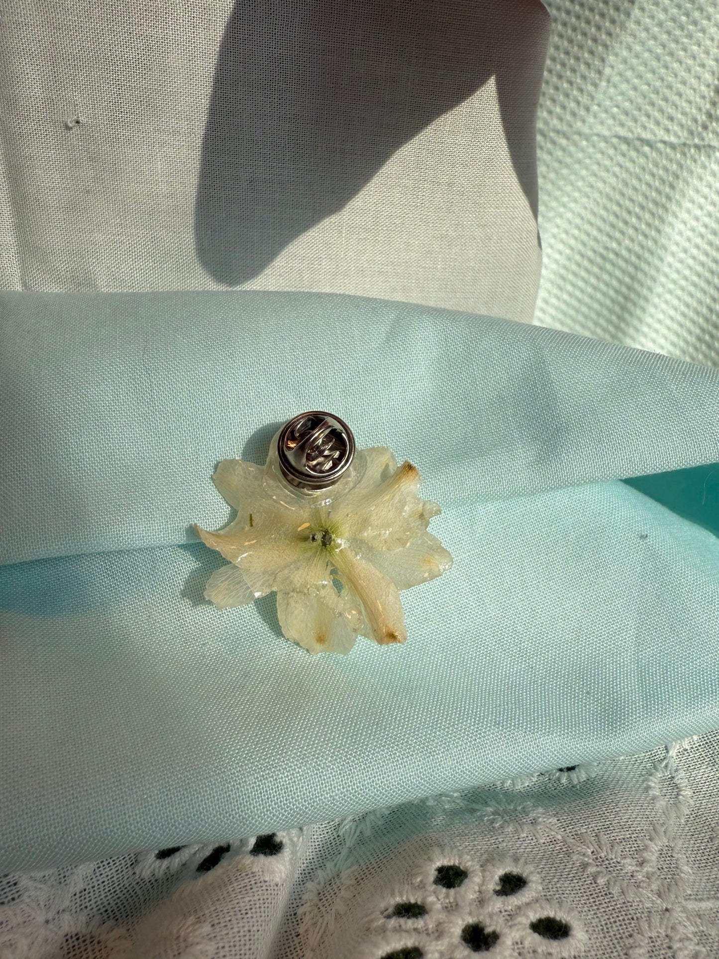 White flower pin
